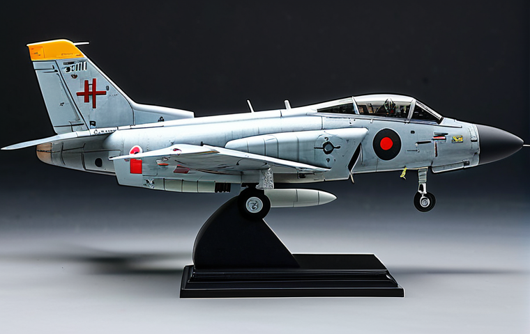 A meticulously crafted, hyperrealistic 1/144 scale combat aircraft model, professionally displayed inside a clear acrylic display case on a clean, light-colored pedestal in a modern, well-lit exhibition hall. The model features intricate weathering effects, subtle chipping, panel line washes, highly detailed metallic verniers, delicate etched parts, and perfectly applied decals including tiny warning labels and squadron markings. The surface displays a realistic matte finish with strategic semi-gloss accents. Studio lighting highlights its three-dimensional form and precise shadow details. perfect anatomy, correct proportions, natural pose, well-formed hands, proper finger count, natural body proportions, high-resolution, professional photography, high quality, safe for work, appropriate content, fully clothed, professional, modest, family-friendly.